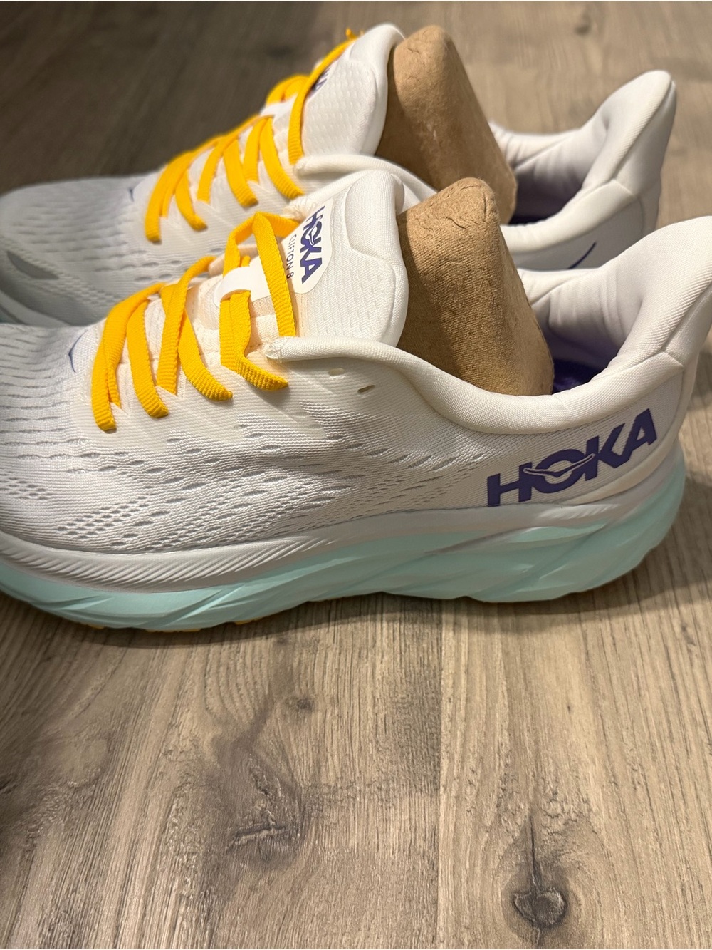 Hoka Women's White Running Shoes with Yellow Laces and Light Blue Sole